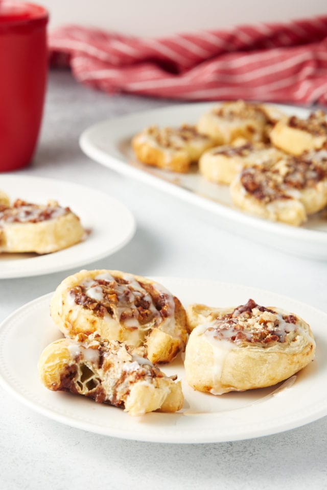 Apple Butter Pinwheels served on white plates and a white serving tray