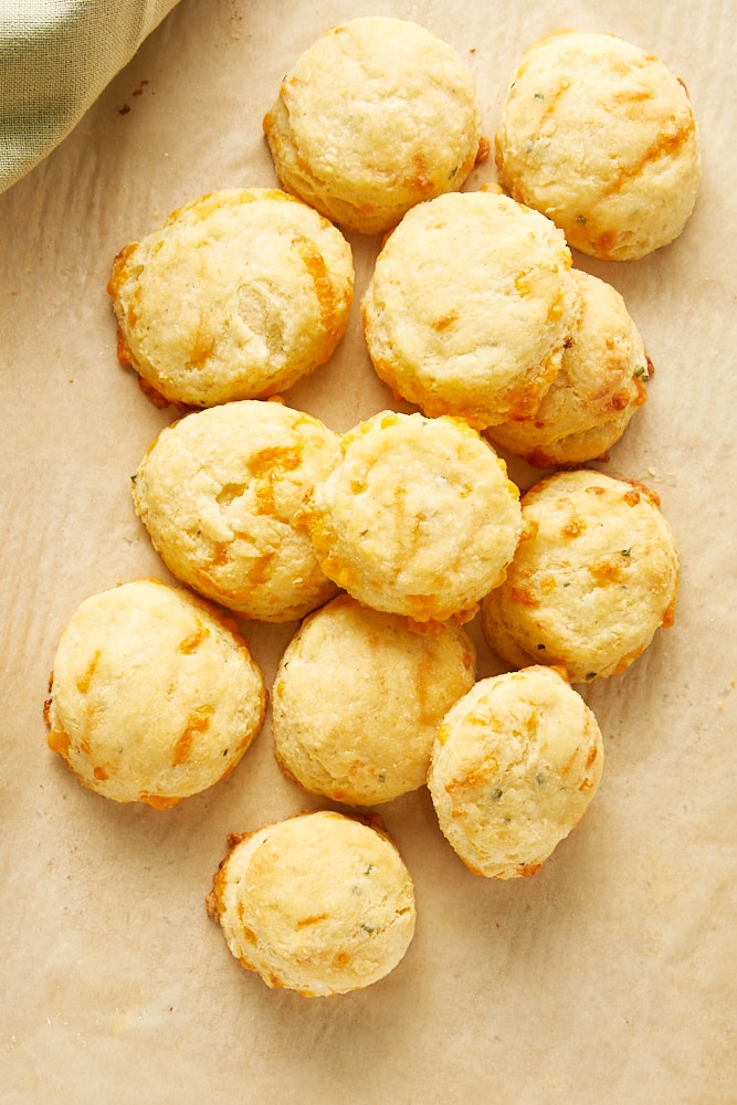 overhead view of Cheddar and Chive Cornmeal Biscuits on parchment paper