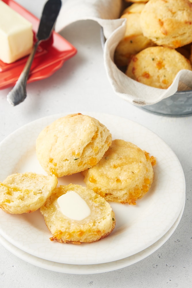 Cheddar and Chive Biscuit split open and spread with butter