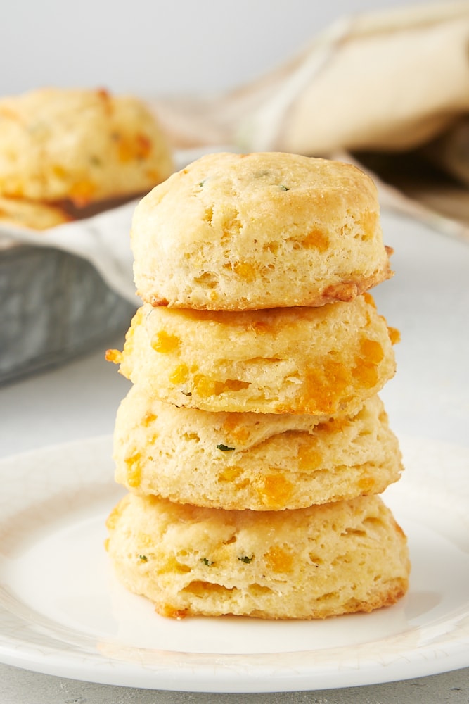 stack of Cheddar and Chive Cornmeal Biscuits on a white plate