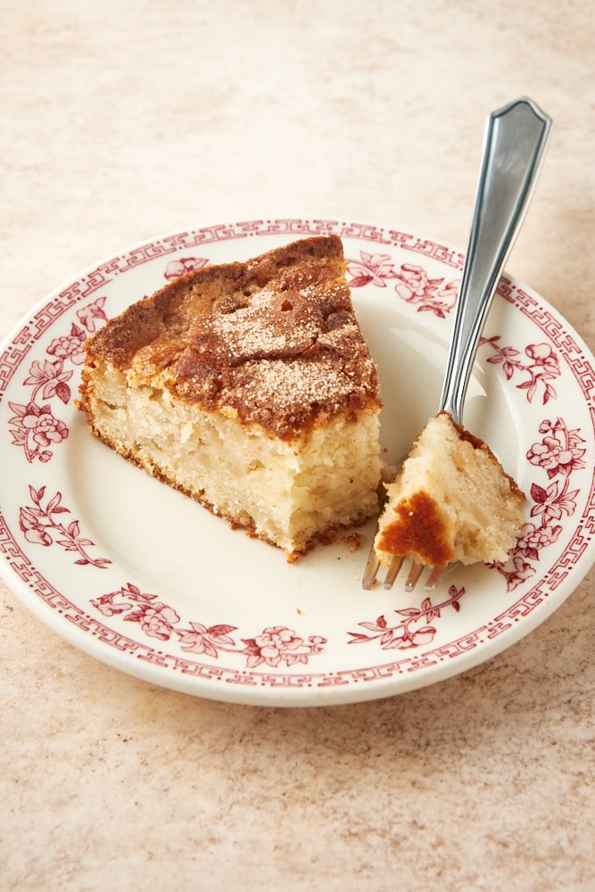 slice of Cinnamon Pear Cake on a red floral-rimmed white plate