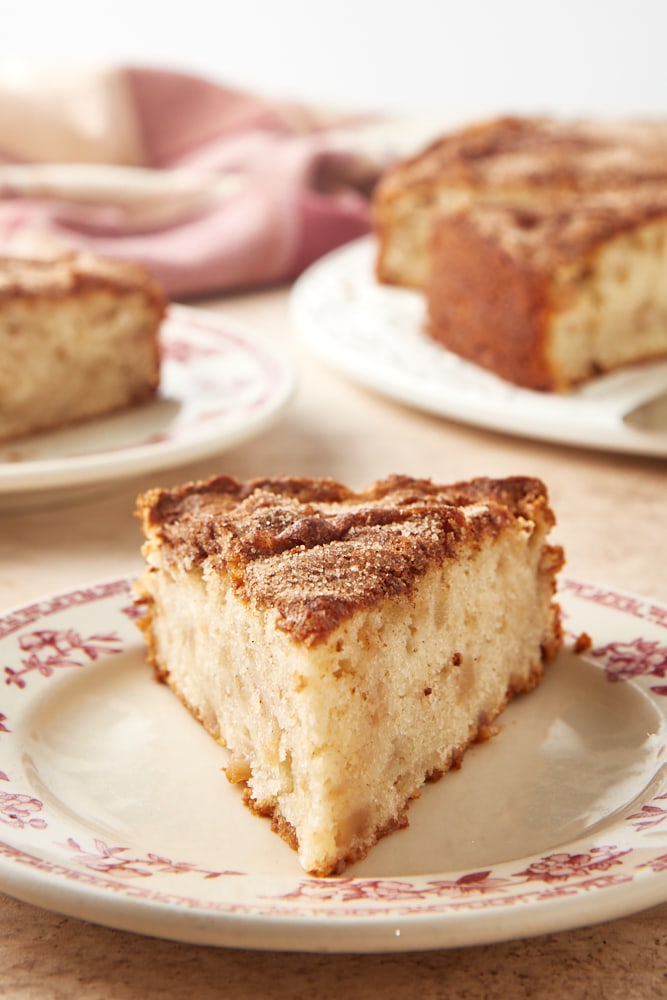 slice of Cinnamon Pear Cake on a red floral-rimmed white plate
