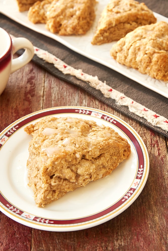 a Cinnamon Oat Scone on a red-rimmed white plate