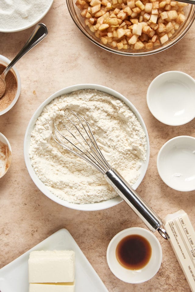 dry ingredients for pear cake mixed in a glass mixing bowl