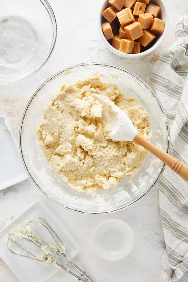overhead view of cream cheese pie crust dough in a glass mixing bowl