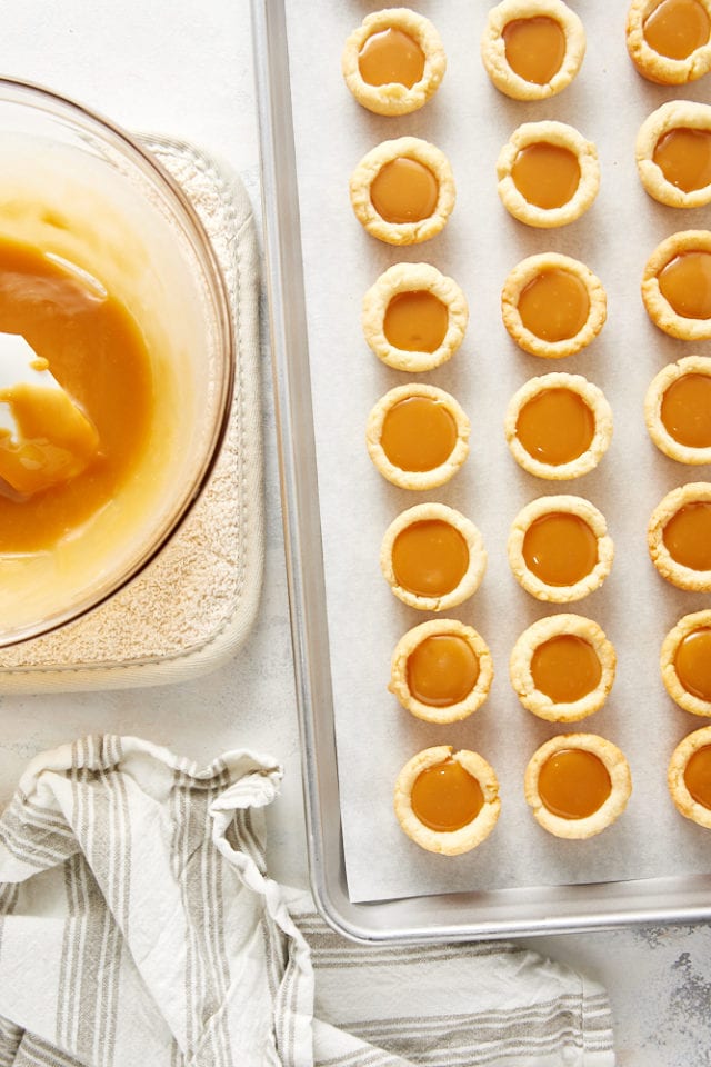 overhead view of mini tarts filled with a caramel filling