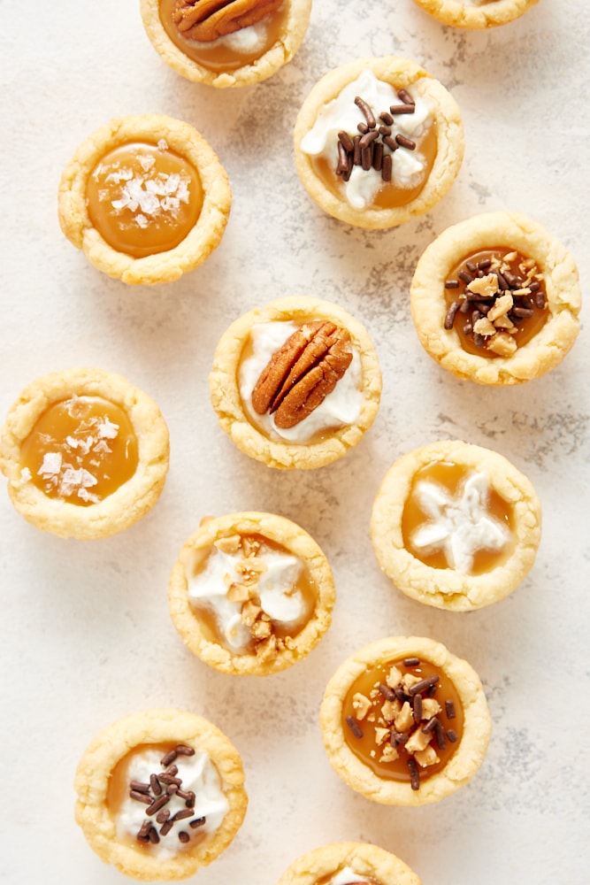 overhead view of Mini Caramel Tarts with various toppings