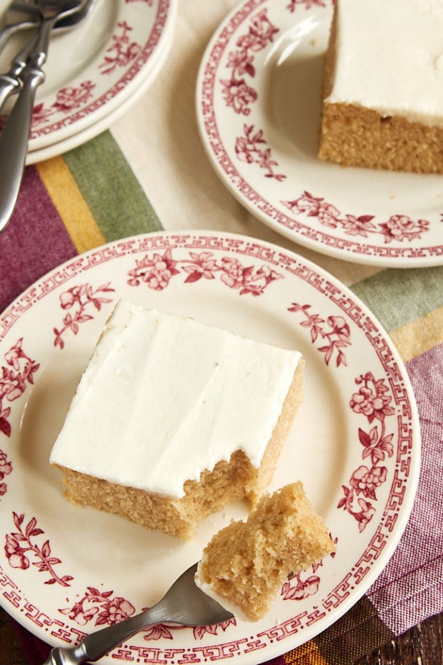 slices of Brown Sugar Spice Cake on red floral-rimmed plates