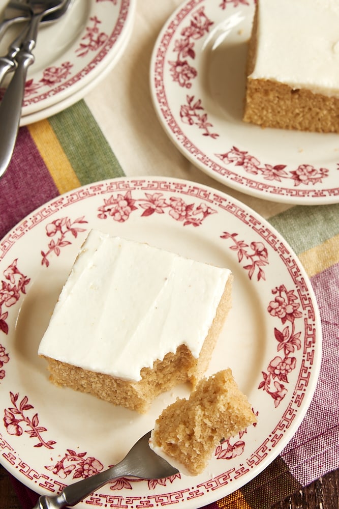 Slices of Brown Sugar Spice Cake on red floral-rimmed plates