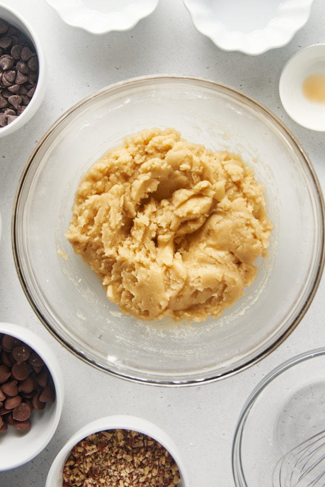 overhead view of Triple Chocolate Chip Cookie Brittle dough in a glass mixing bowl