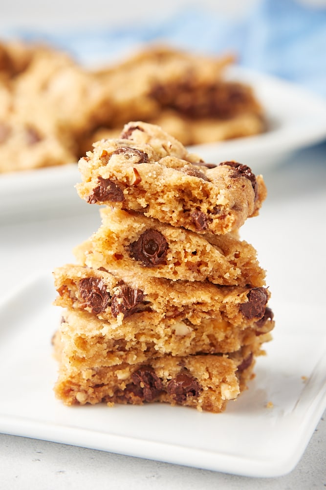 stack of Triple Chocolate Chip Cookie Brittle pieces on a square white plate