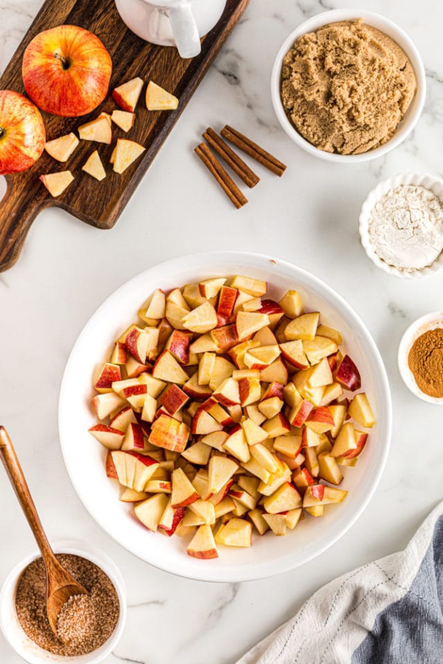 overhead view of chopped apples in a white mixing bowl