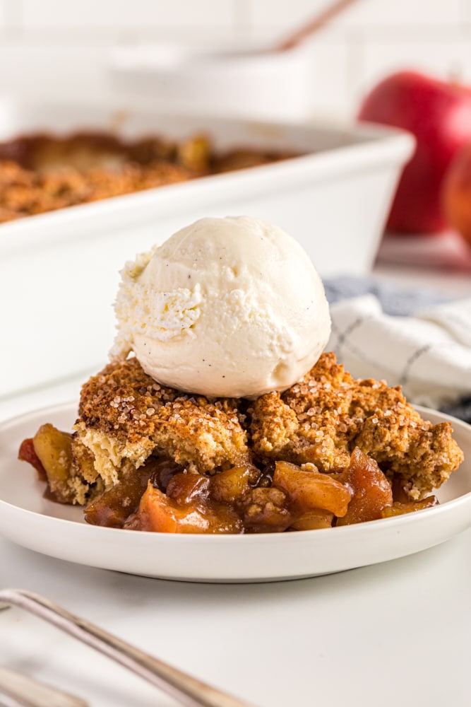 serving of Brown Sugar Apple Cobbler topped with ice cream and served on a white plate