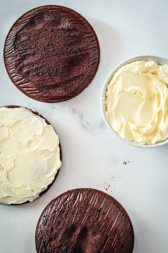 Overhead view of chocolate peppermint layer cake being assembled