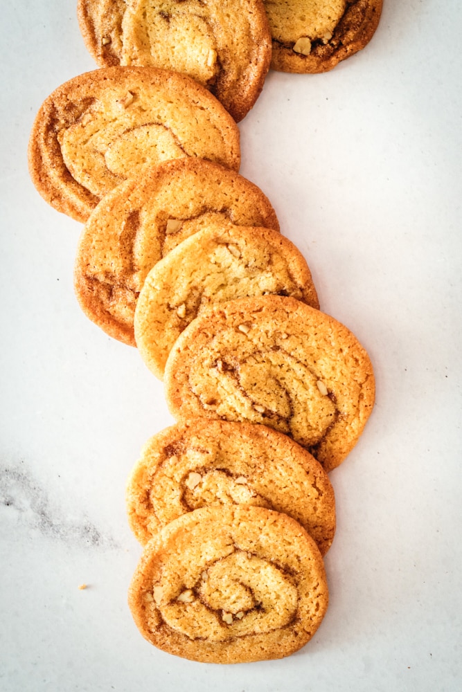 Line of Cinnamon Roll Cookies on marble slab