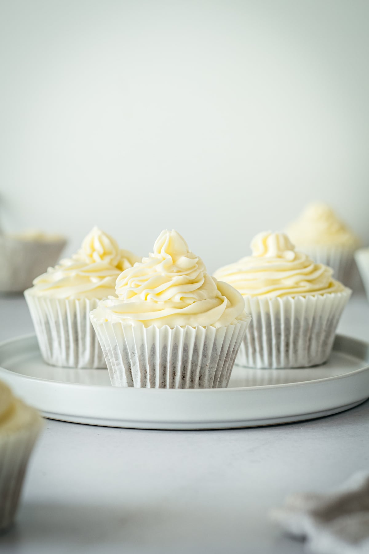 Three gingerbread cupcakes in wrappers on plate