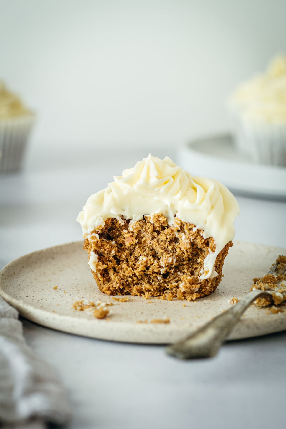 Gingerbread cupcake on plate, cut in half with fork