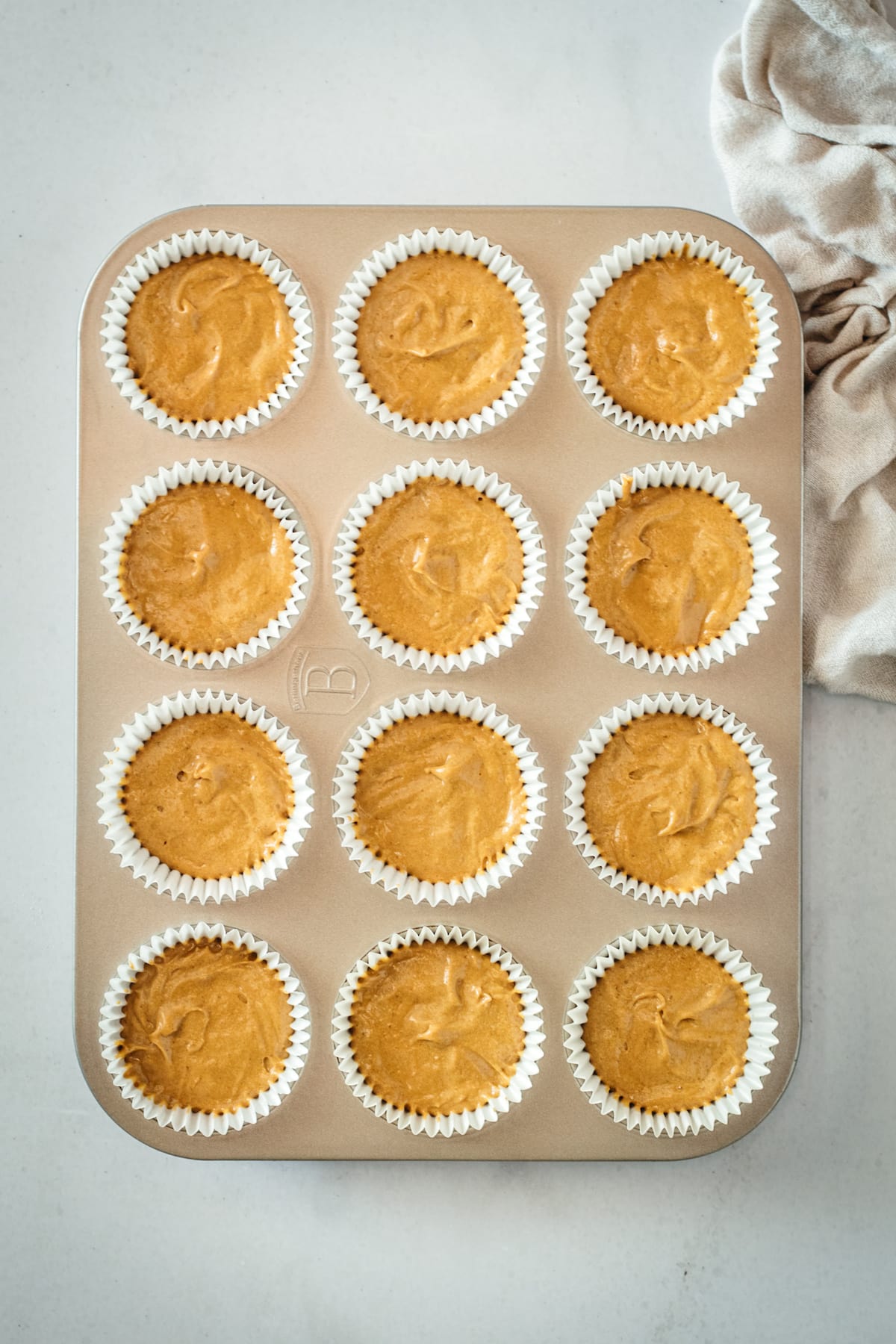 Overhead view of unbaked gingerbread cupcakes in muffin tin