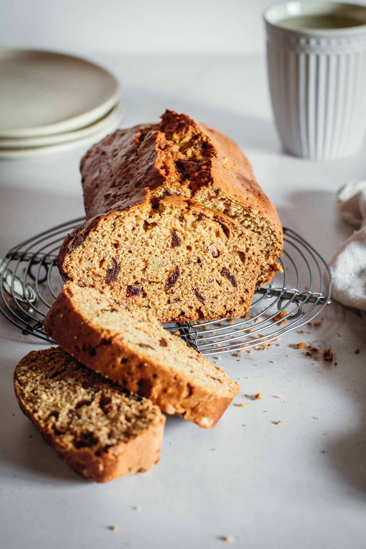 Sliced Kahlua date nut bread on a round cooling rack.