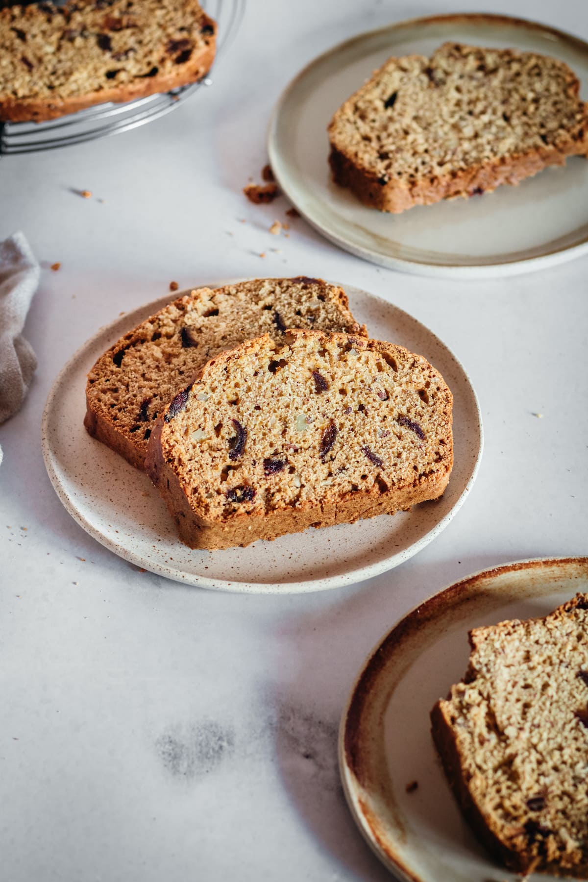 Kahlua date nut bread slices on plates.