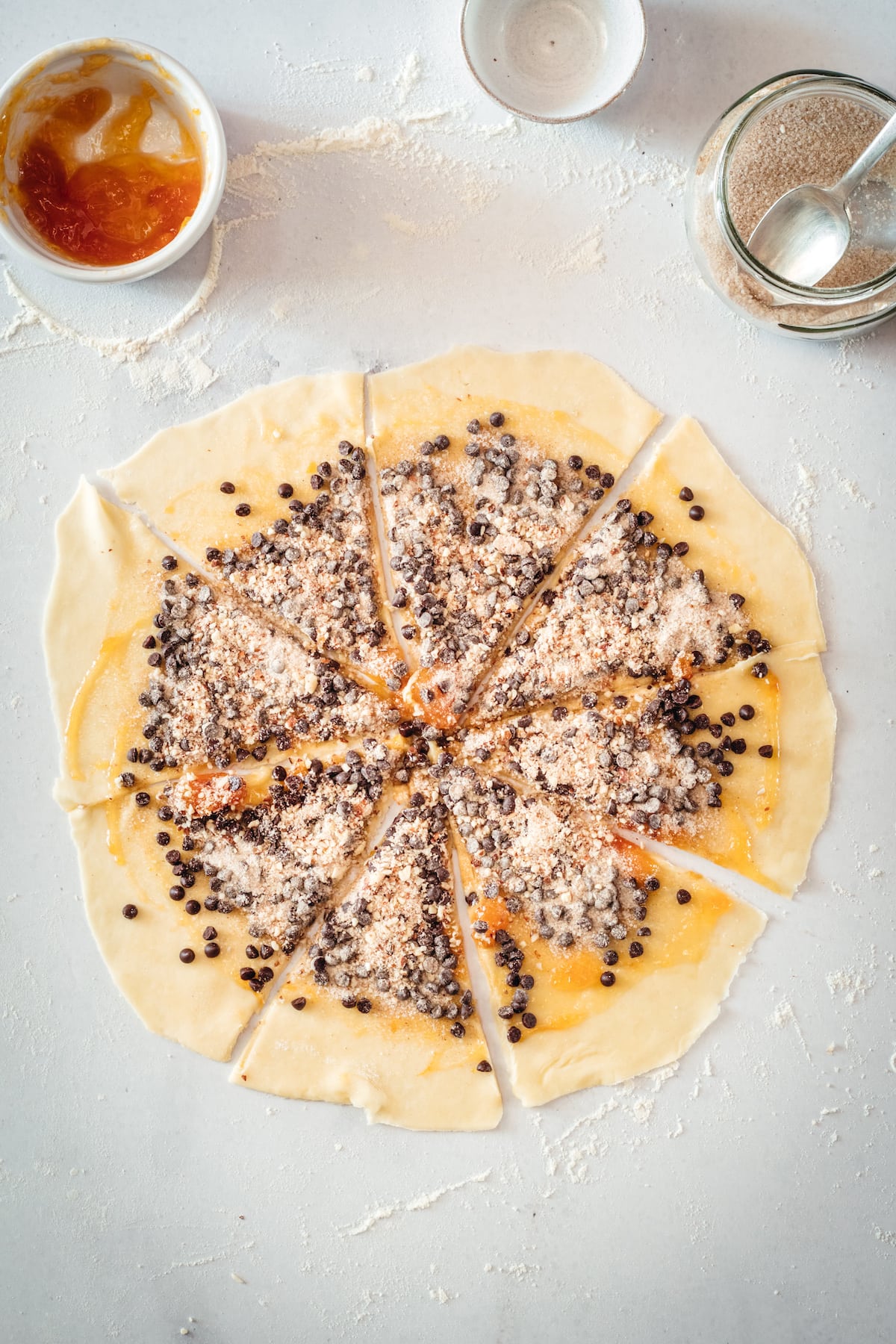 Triangles of rugelach dough topped with filling ingredients