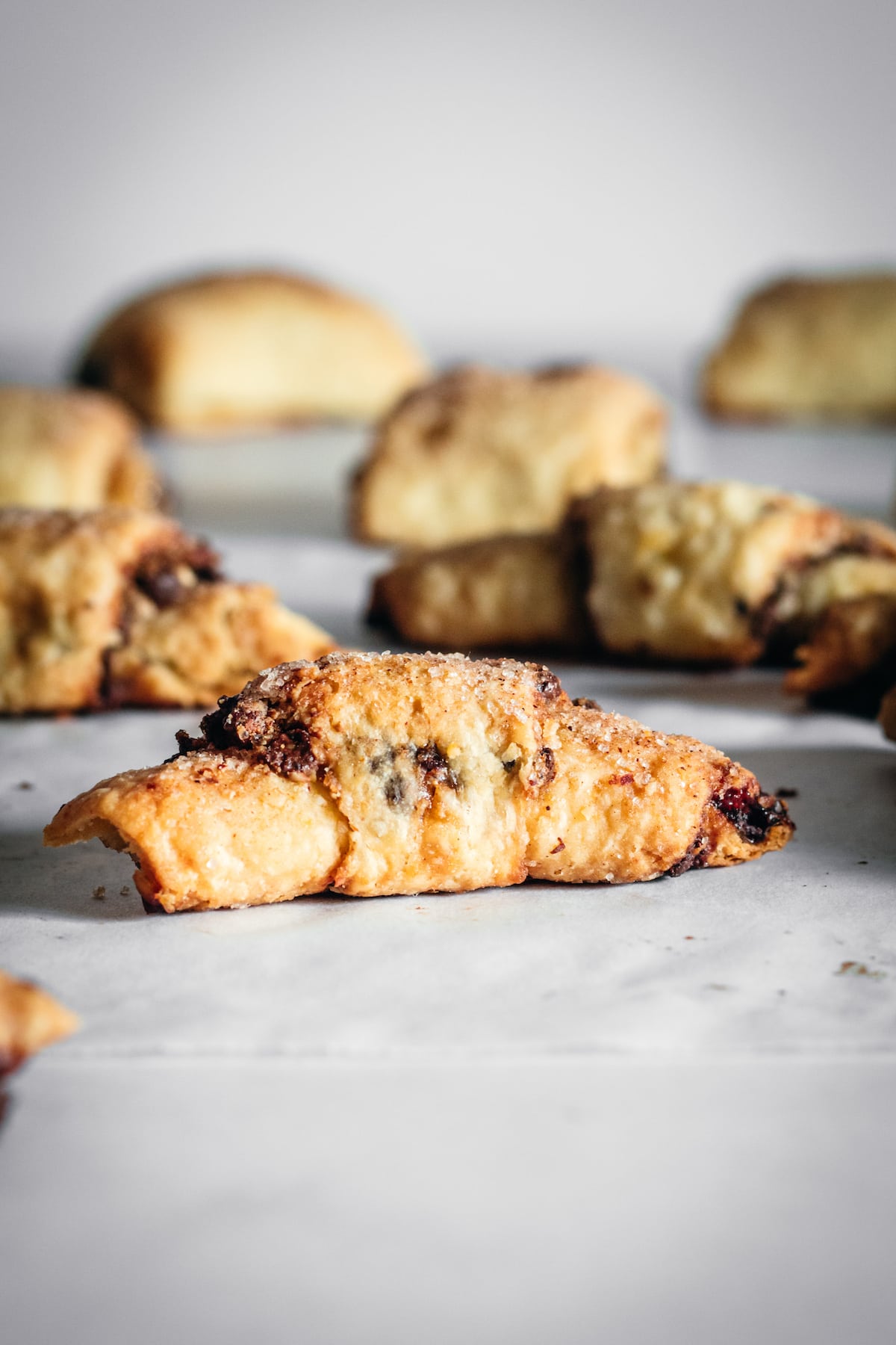 Crescent rugelach on parchment lined marble slab
