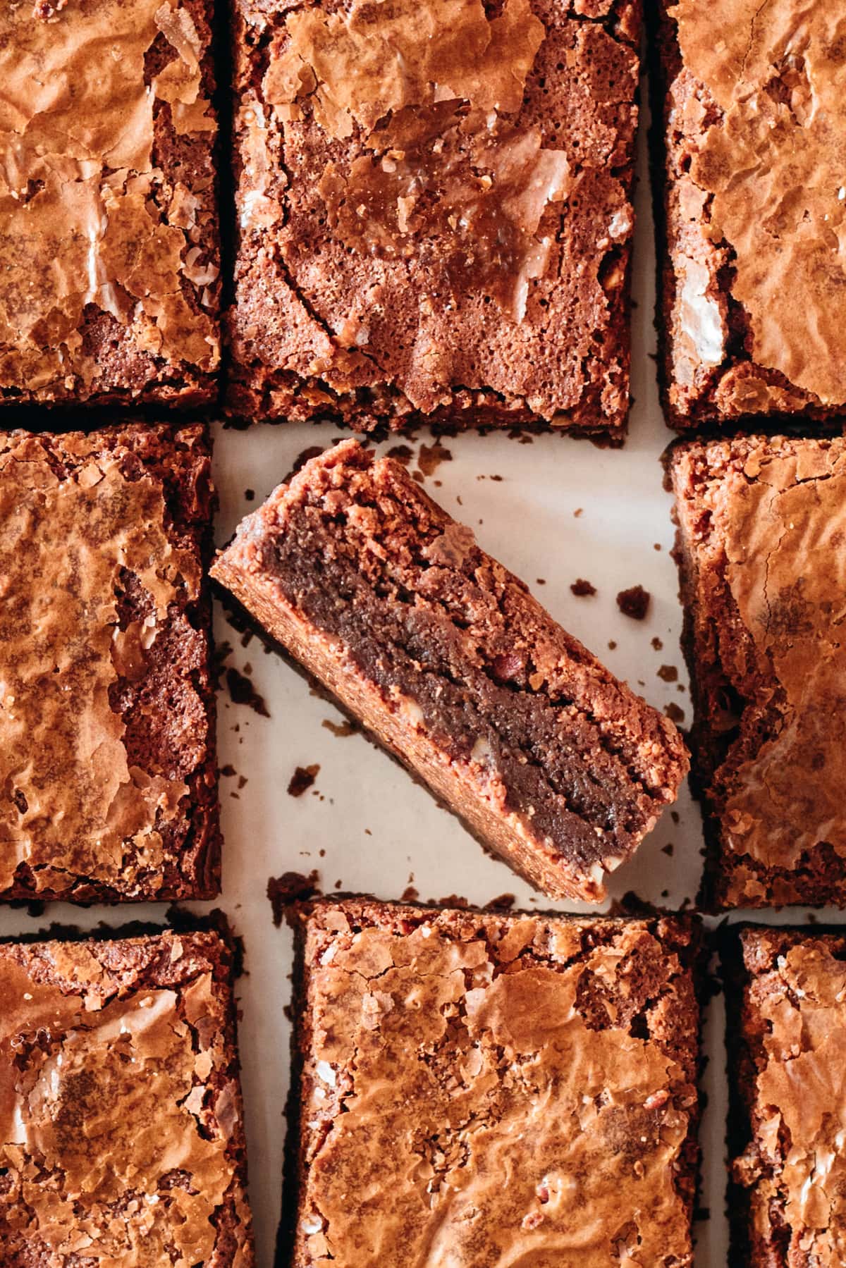 Overhead view of brownies cut into squares, with center brownie set on its side