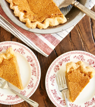 overhead view of slices of Brown Butter Chess Pie on red floral-rimmed white plates