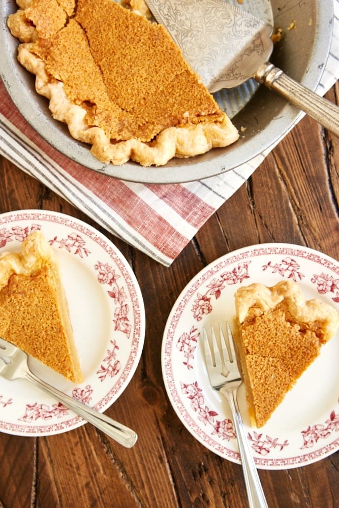overhead view of slices of Brown Butter Chess Pie on red floral-rimmed white plates