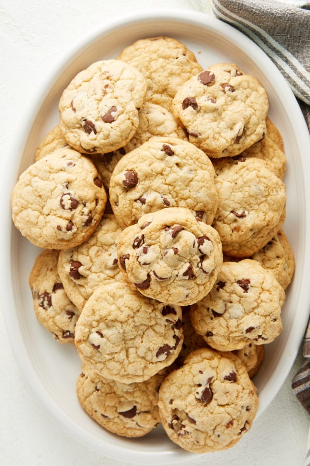 overhead view of Chewy Chocolate Chip Cookies on an oval white tray