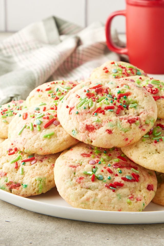 pile of Soft Christmas Sprinkle Sugar Cookies on a white serving plate