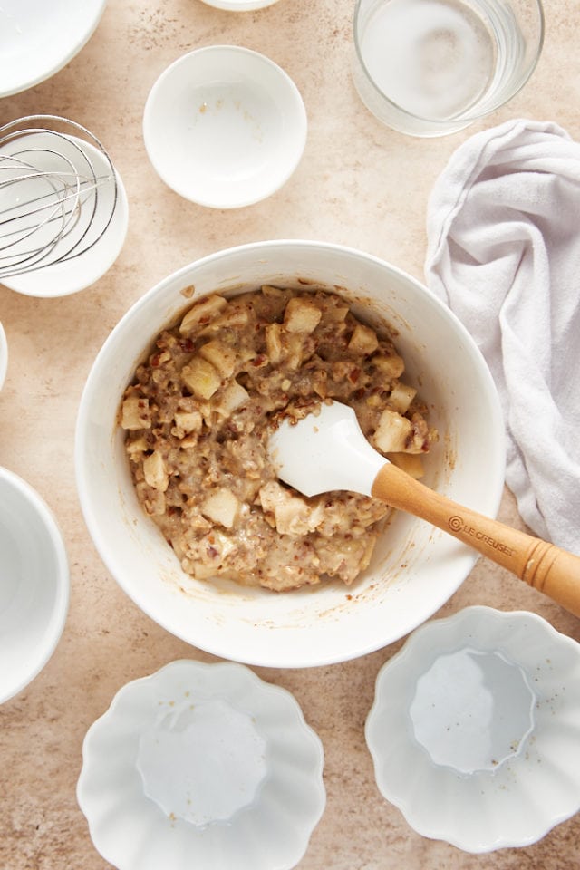 overhead view of mixed pear pudding cake batter in a white mixing bowl