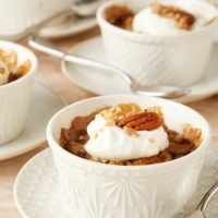 Ginger Pear Pudding Cakes in white ramekins on white and beige plates