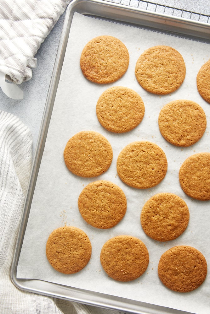 overhead view of freshly baked Maple Ginger Cookies on a parchment-lined baking sheet