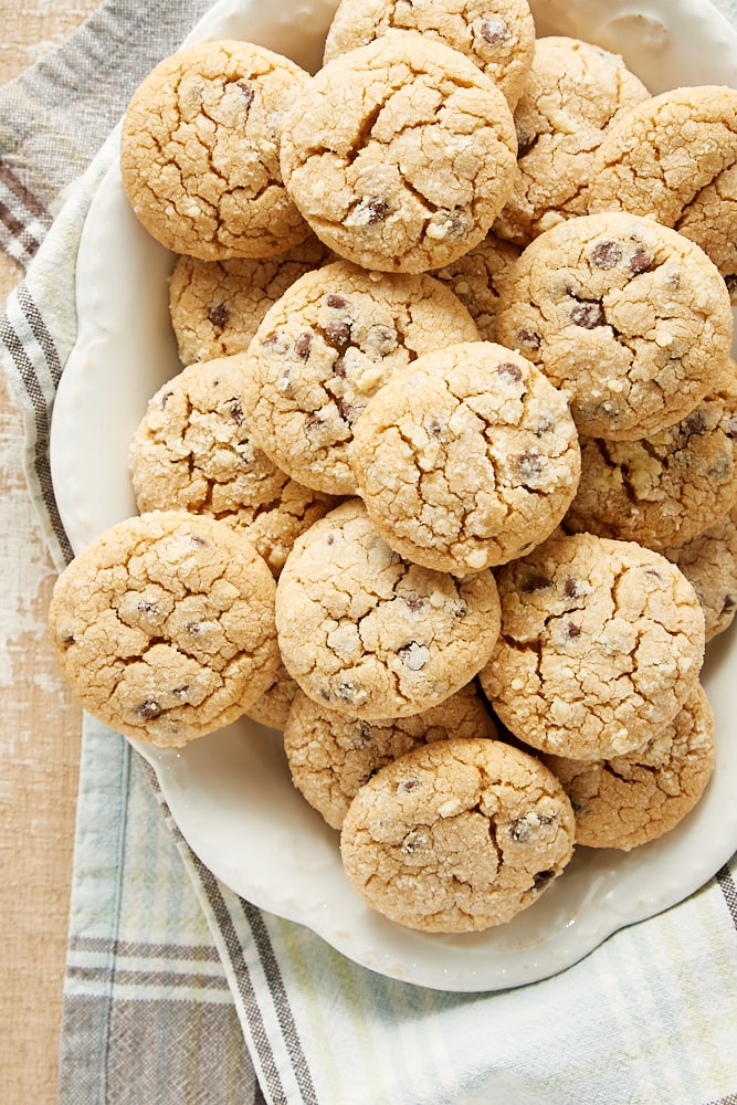 Overhead view of peanut butter crinkle cookies on an oval white plate.