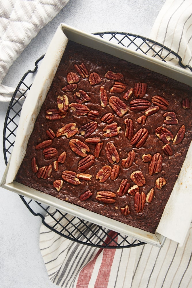 overhead view of freshly baked Pecan Lovers' Brownies in a square baking pan on a wire rack