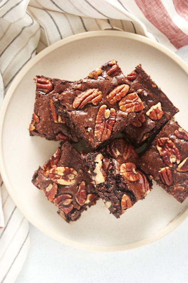 overhead view of a pile of Pecan Lovers' Brownies on a beige plate