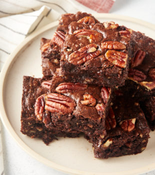 pile of Pecan Lovers' Brownies on a beige plate
