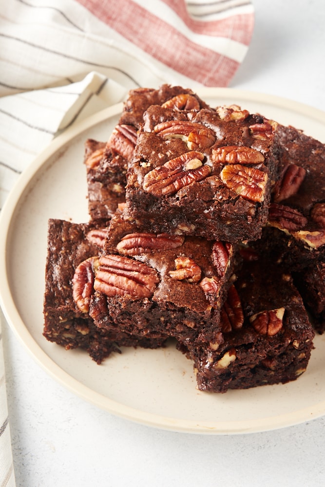 pile of Pecan Lovers' Brownies on a beige plate