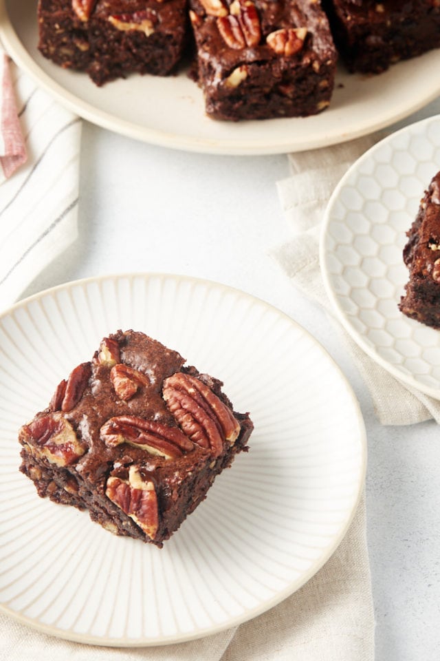 a Pecan Lovers' Brownie served on a white and beige plate