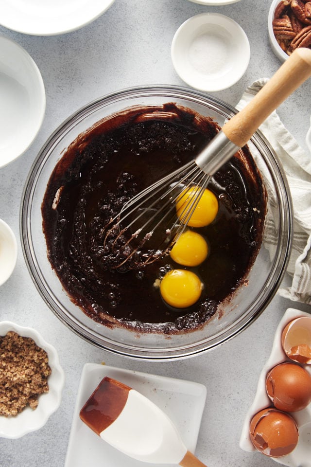 overhead view of eggs added to brownie batter