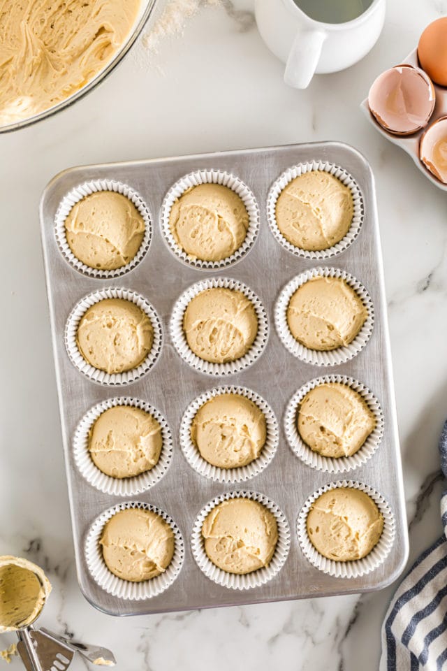 overhead view of Brown Sugar Pound Cakes batter in a lined muffin pan