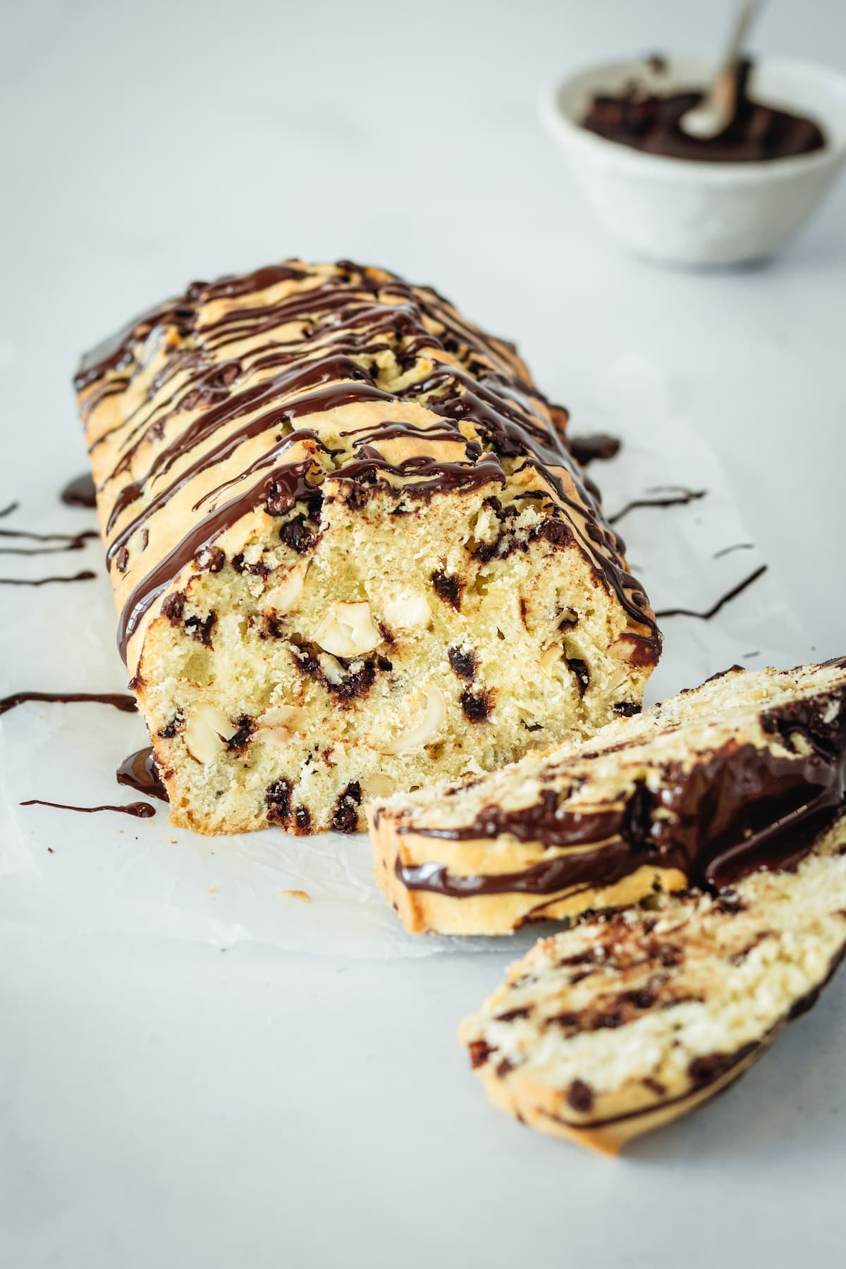 Chocolate chip cashew bread loaf with two pieces sliced off