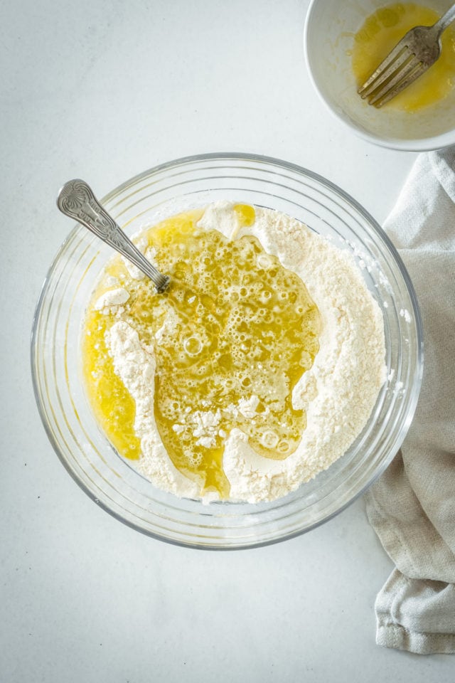 Overhead view of dry ingredients being mixed into bread batter