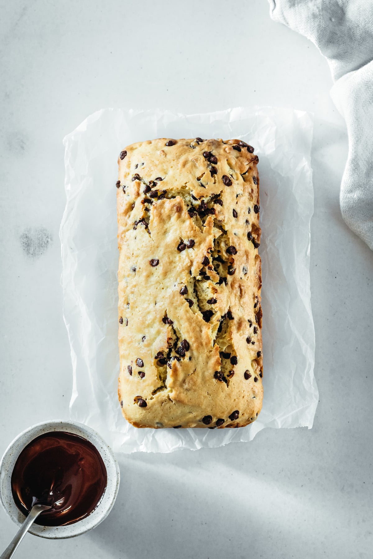 Overhead view of chocolate chip cashew bread before drizzling with chocolate