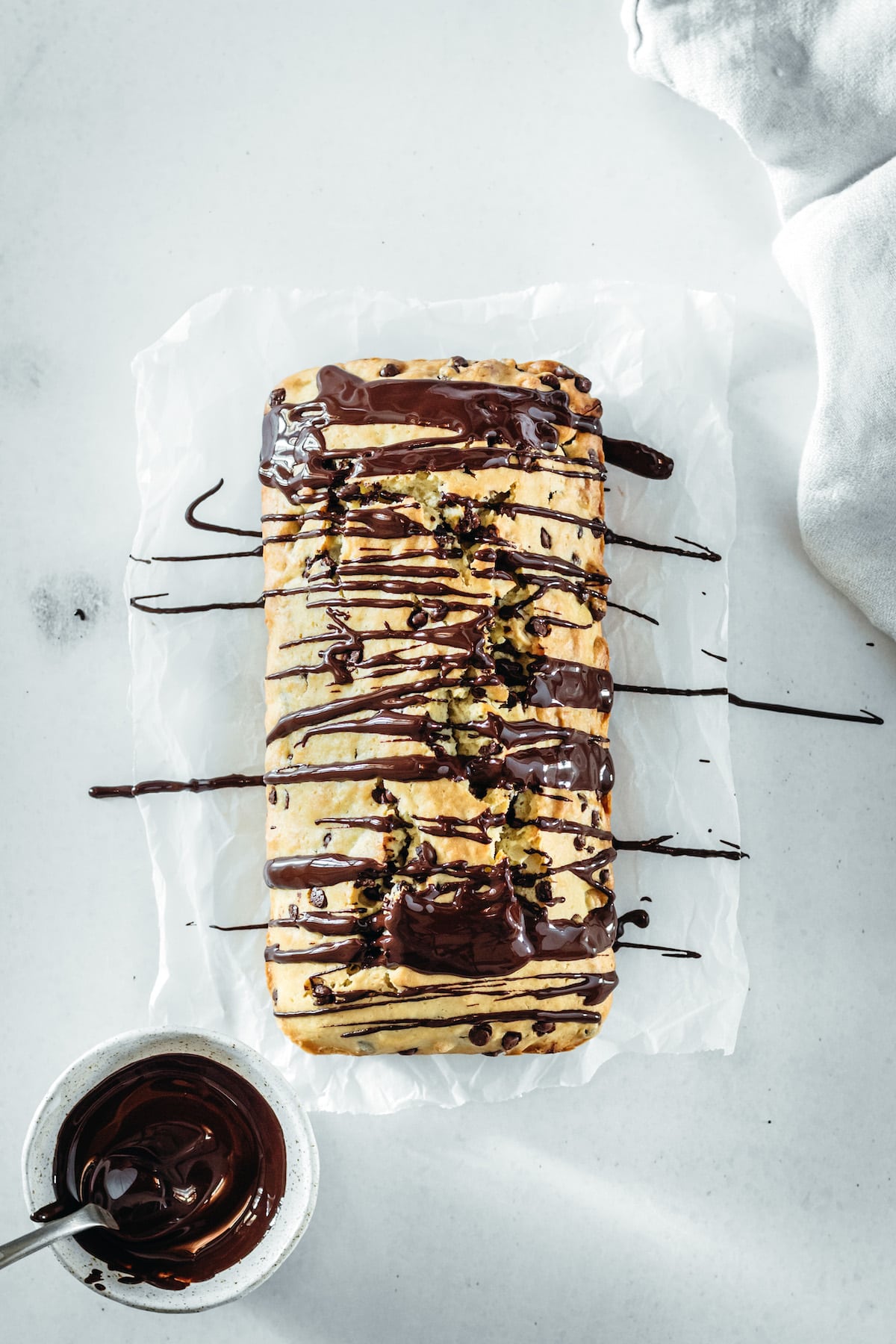 Overhead view of cashew bread after drizzling with melted chocolate