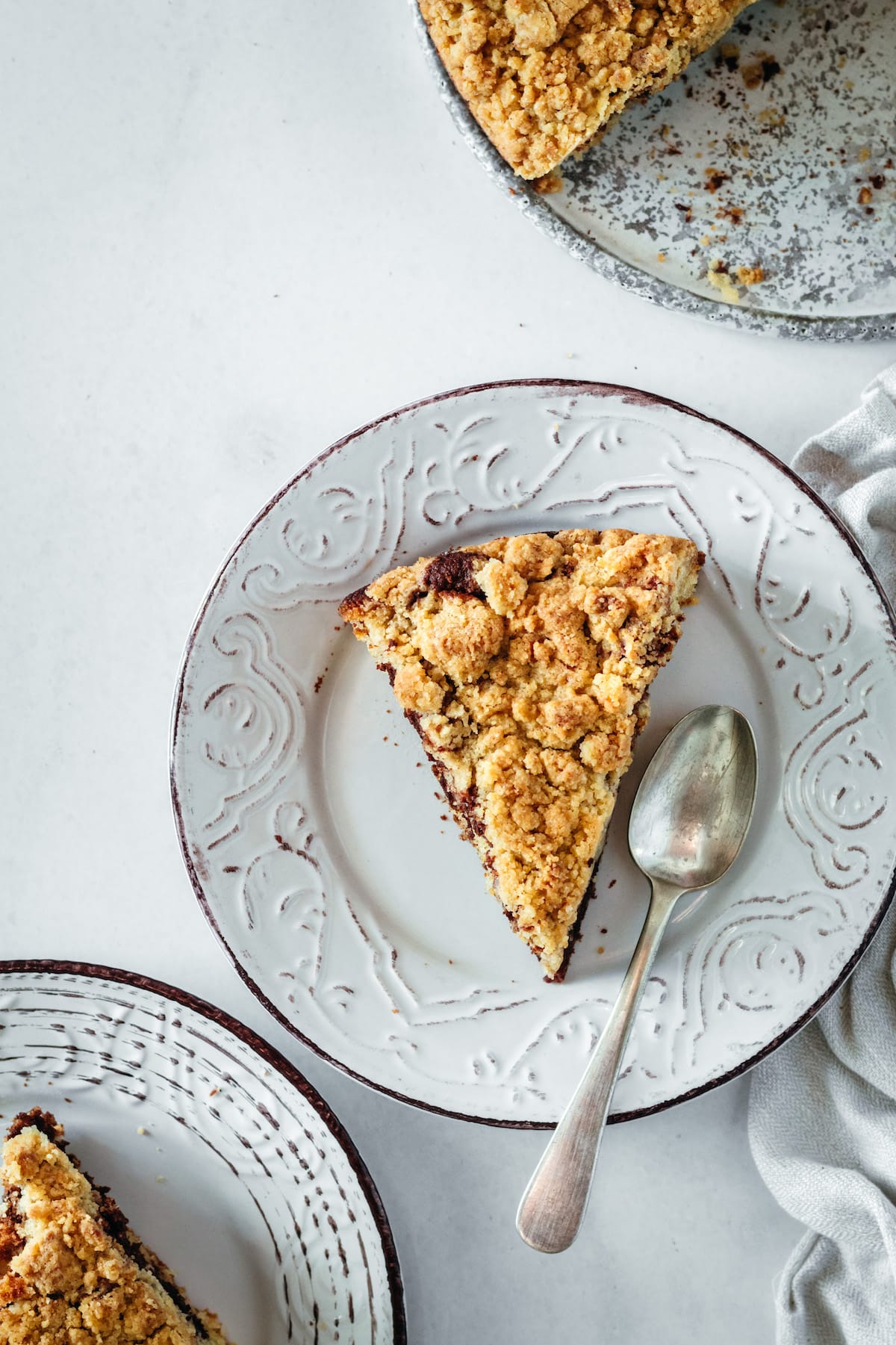 Overhead view of coffee cake slices on plate with spoon