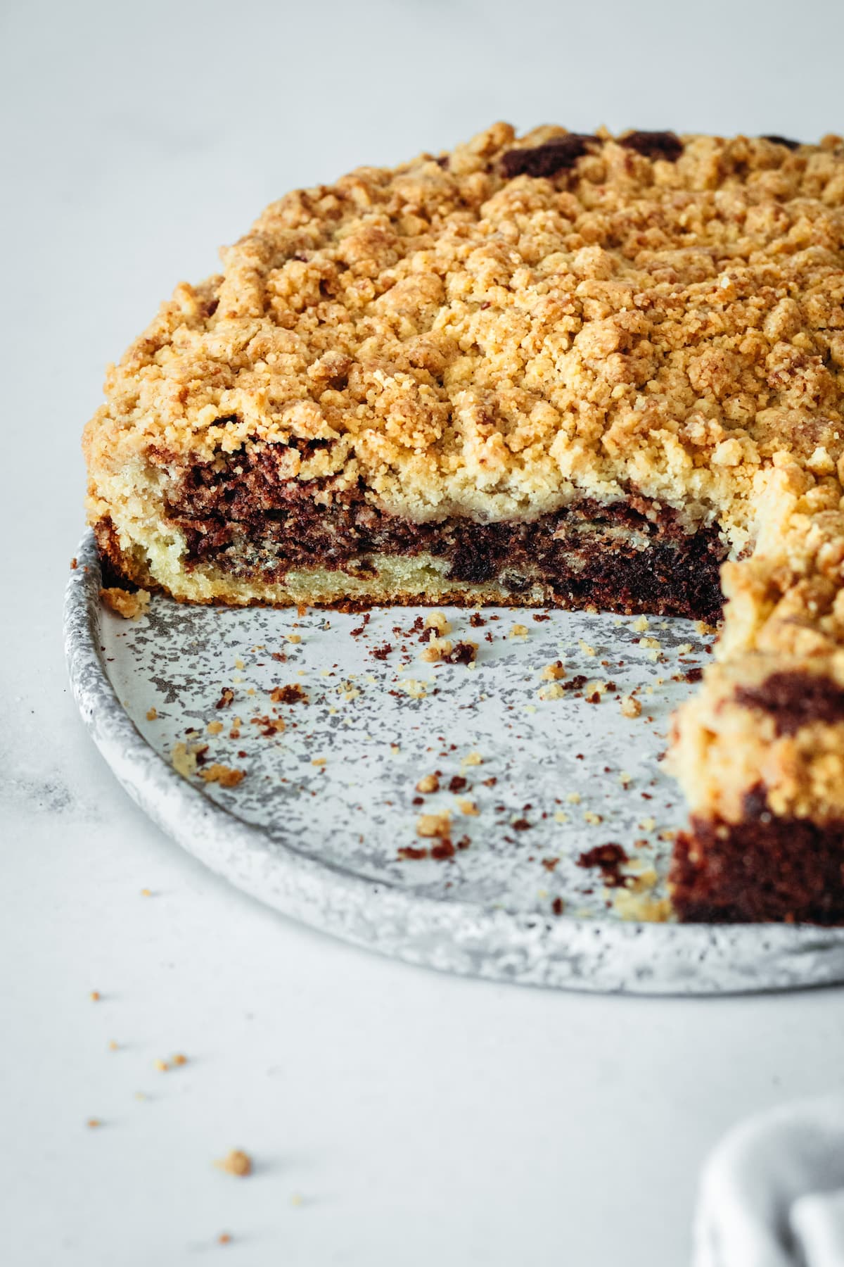 Coffee cake on plate with two slices removed to show inside