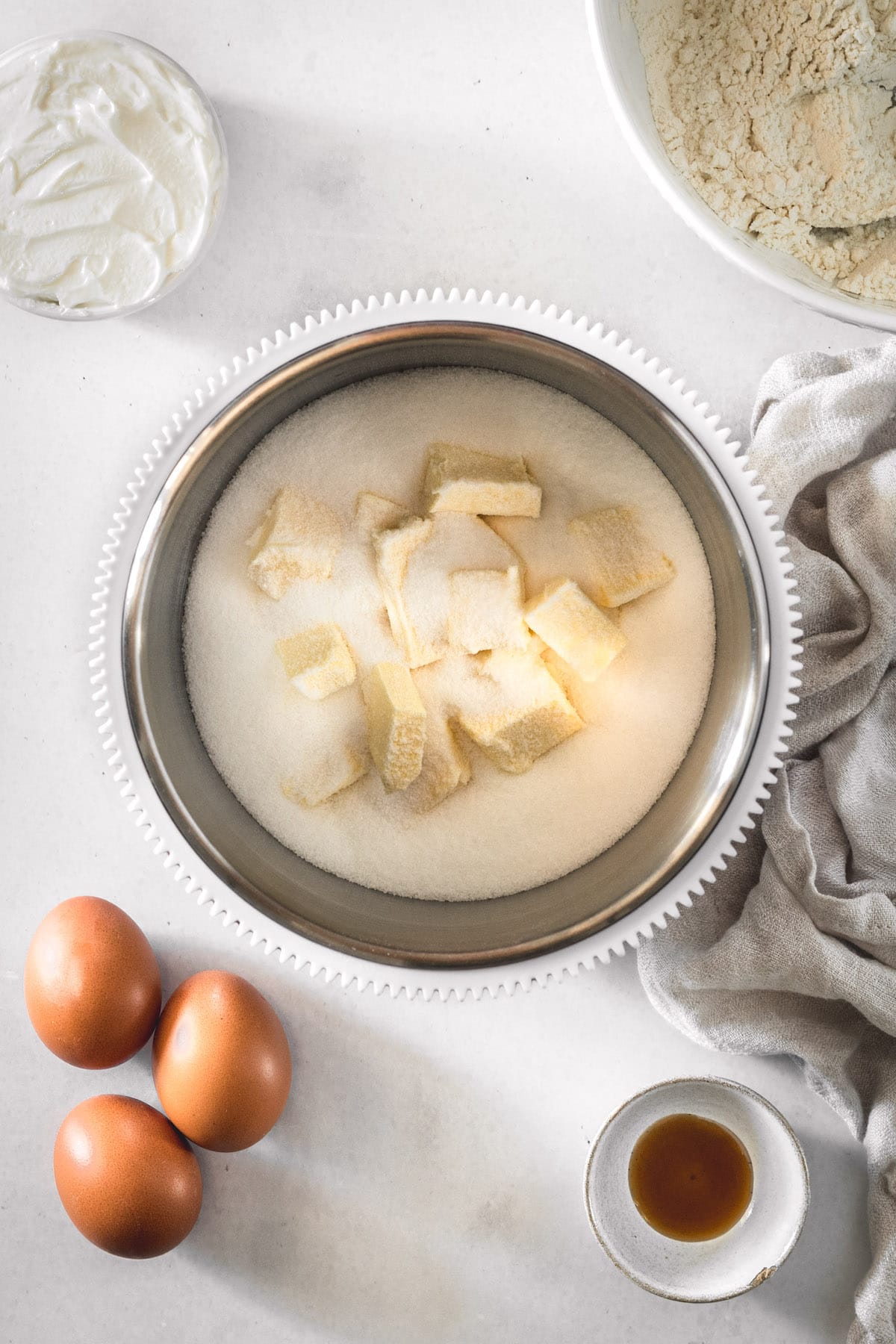 Overhead view of butter and sugar in mixing bowl