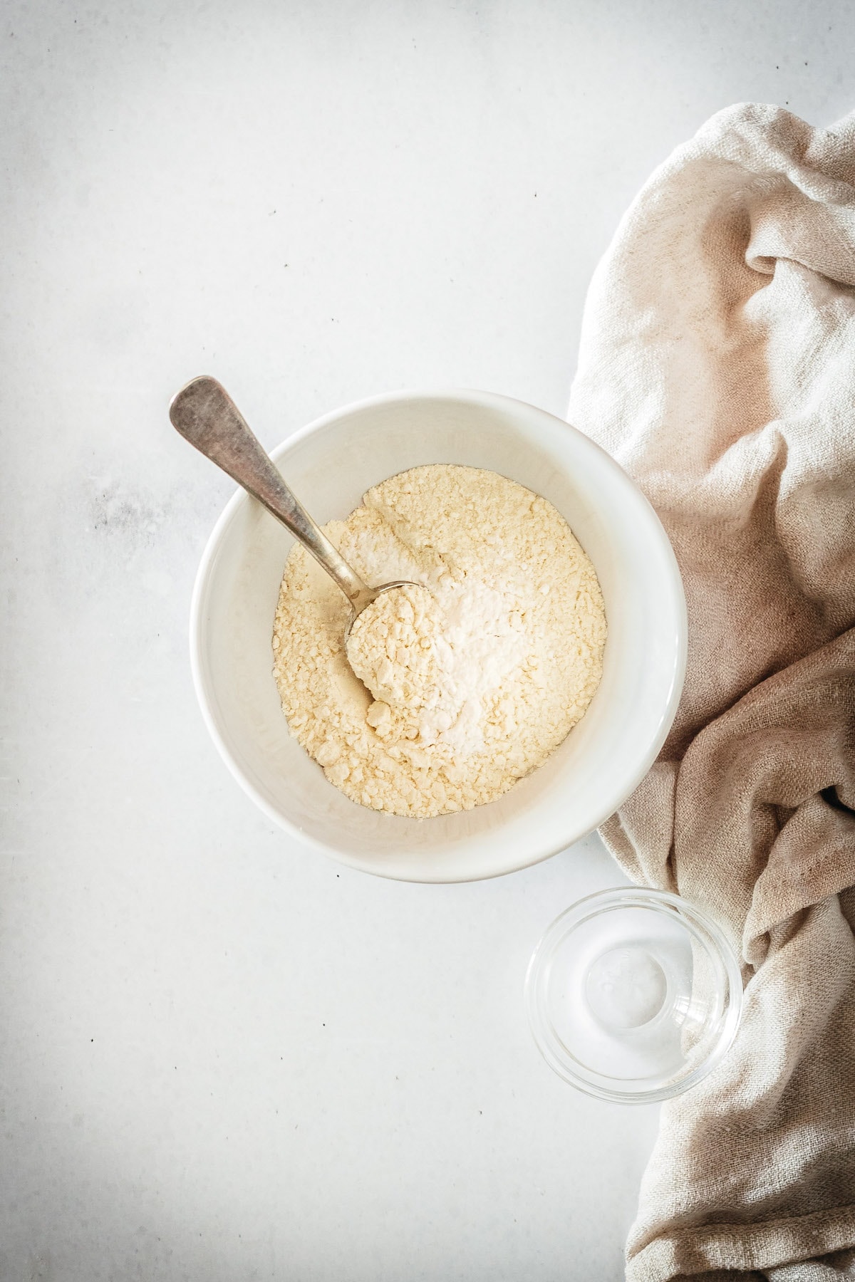 Overhead view of dry ingredients in small bowl with spoon